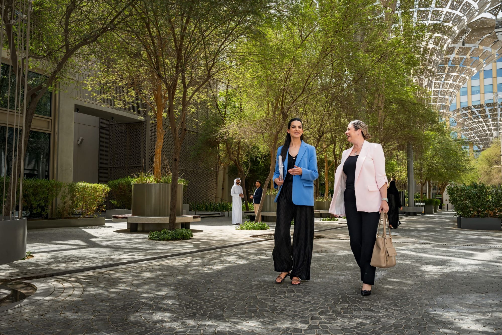 Two women walking towards their workplace at Expo City Dubai 