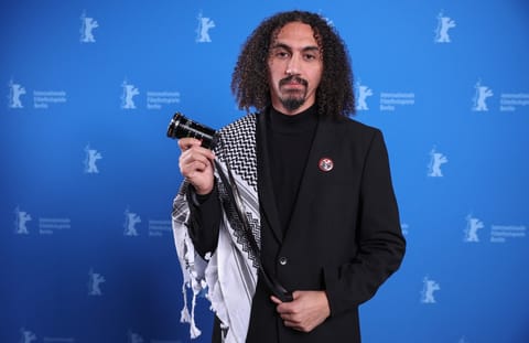 Palestinian director Abdallah Alkhatib poses during a photocall after winning the GWFF Best Feature Film Debut Award for “Chronicles From the Siege” at the 76th Berlinale, Europe's first major film festival of the year, in Berlin on February 21, 2026.
