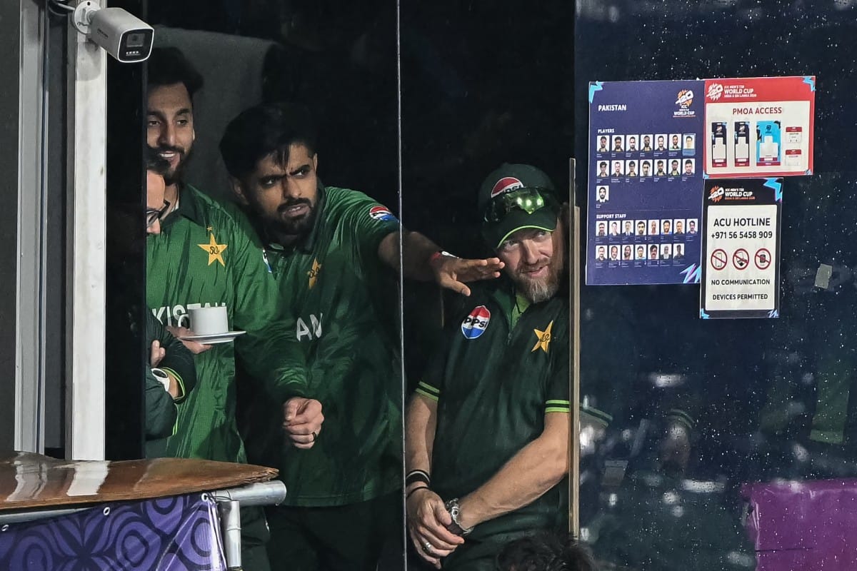 Pakistan's Babar Azam (C) and his captain Salman Agha (L) react after the 2026 ICC Men's T20 Cricket World Cup Super Eight match between Pakistan and New Zealand was called off due to rain at the R Premadasa Stadium in Colombo on February 21, 2026.