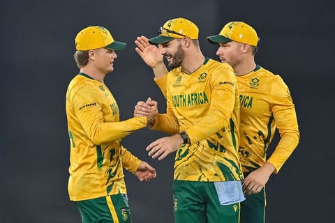 South Africa's captain Aiden Markram (C) celebrates with teammates Ryan Rickelton (L) and David Miller (R) after their team's win at the end of the 2026 ICC Men's T20 Cricket World Cup Super Eights match between India and South Africa at the Narendra Modi Stadium in Ahmedabad on February 22, 2026.