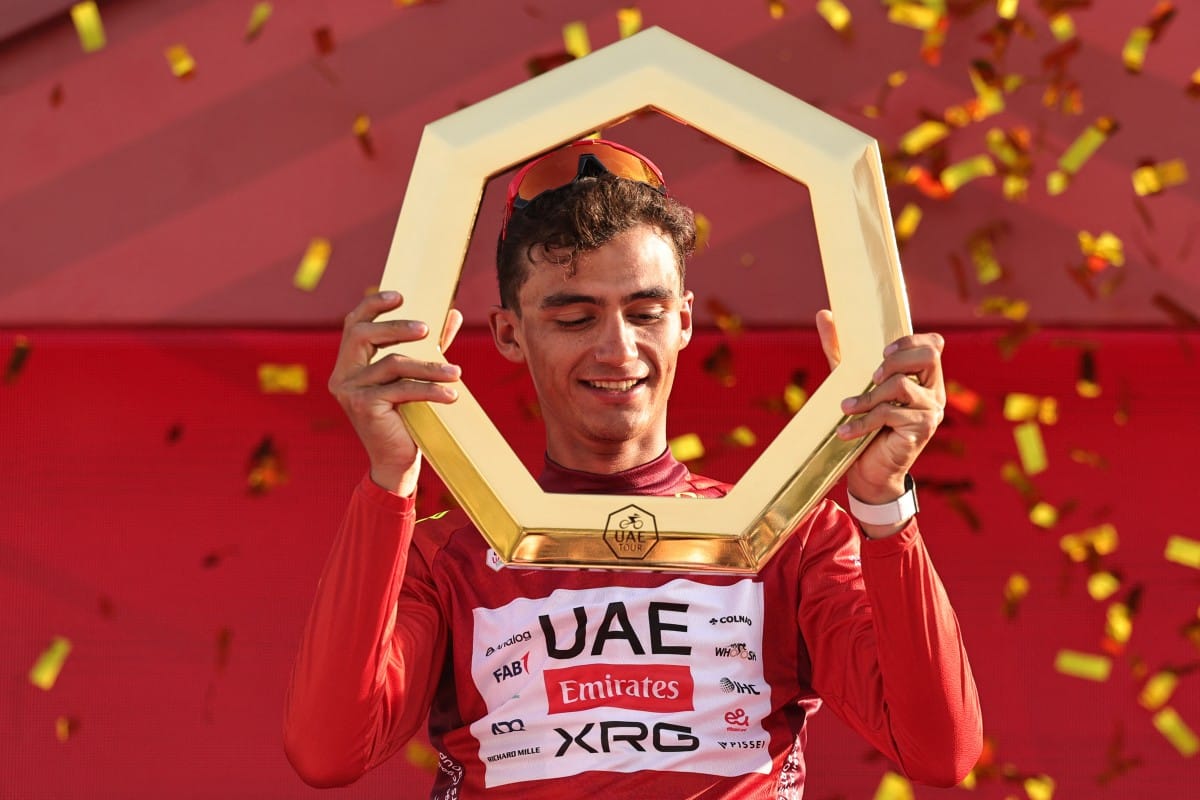 Championship first place winner UAE Team Emirates's Mexican rider Isaac Del Toro Romero celebrates on the podium after the seventh and final stage of the UAE Tour cycling event from Zayed National Museum to Abu Dhabi Breakwater in Abu Dhabi on February 22, 2026.