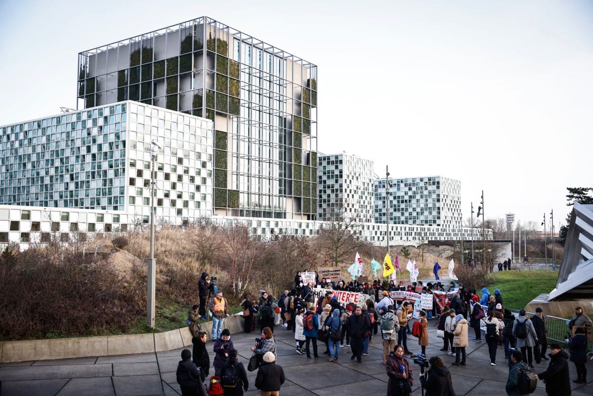 This photograph shows a general view of protestors, rallying in support of the detention of former Philippine's president Rodrigo Duterte, outside of the International Criminal Court (ICC) where he will be questioned by the International Criminal Court on charges of crimes against humanity, in The Hague on February 23, 2026.
