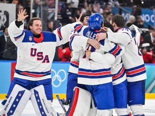 USA players celebrate winning the men's gold medal ice hockey match between Canada and USA at the Milano Santagiulia Ice Hockey Arena 