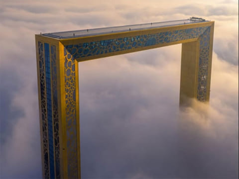 Dubai's iconic landmarks appearing to float amidst the fog.