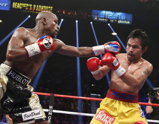 Floyd Mayweather Jr. exchange punches with Manny Pacquiao during their welterweight unification championship bout, May 2, 2015 at MGM Grand Garden Arena in Las Vegas, Nevada.