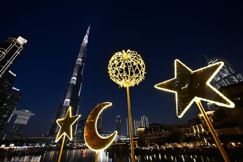 Crescent-shaped festive decorations are pictured near Burj Khalifa in the centre of Dubai on February 24, 2026 during the Muslim holy fasting month of Ramadan.