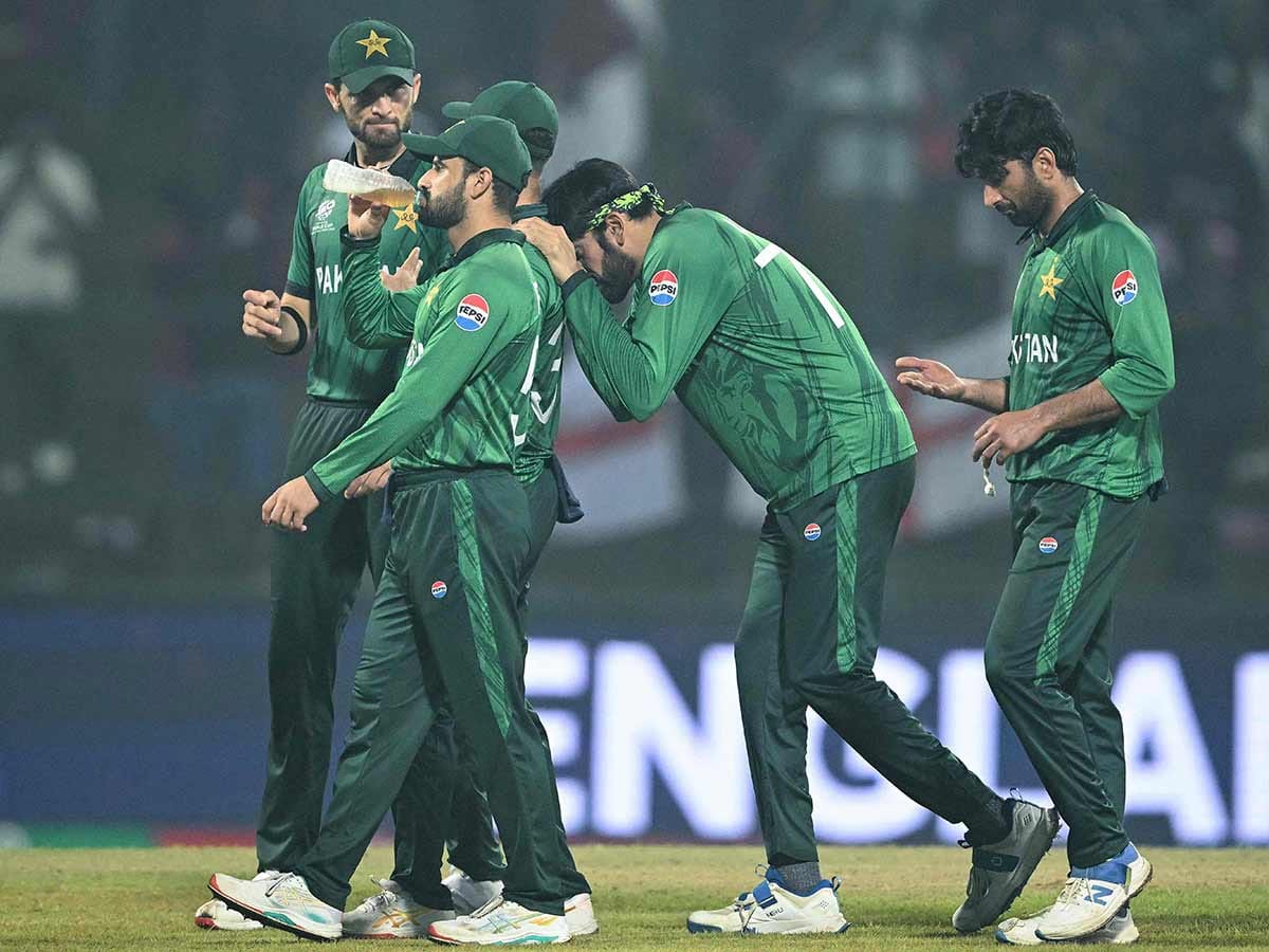 Pakistan players walk back after their defeat during the T20 World Cup Super Eights match against England at the Pallekele International Cricket Stadium in Kandy on February 24, 2026. 