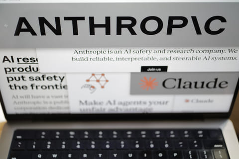 Pages from the Anthropic website and the company's logos are displayed on a computer screen in New York on Thursday, Feb. 26, 2026