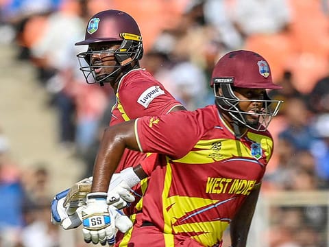 West Indies' Jason Holder (L) and Romario Shepherd run between the wickets during the T20 World Cup Super Eights match against South Africa at Narendra Modi Stadium in Ahmedabad on February 26, 2026. 