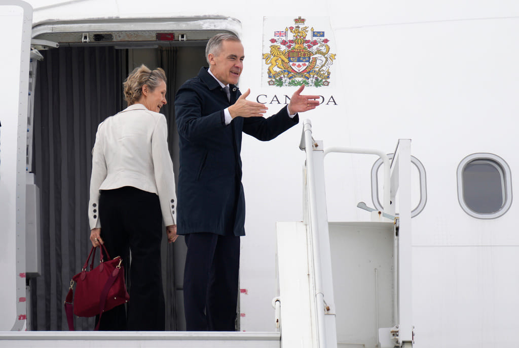 Canadian Prime Minister Mark Carney and his wife Diana Fox Carney board a government plane in Ottawa on Thursday, Feb. 26, 2026. 
