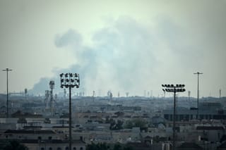 Smoke rises from an area in the direction of Al Udeid Air Base, which houses the Qatar Emiri Air Force and foreign forces including the US, in Doha on February 28, 2026, following a reported Iranian strike.