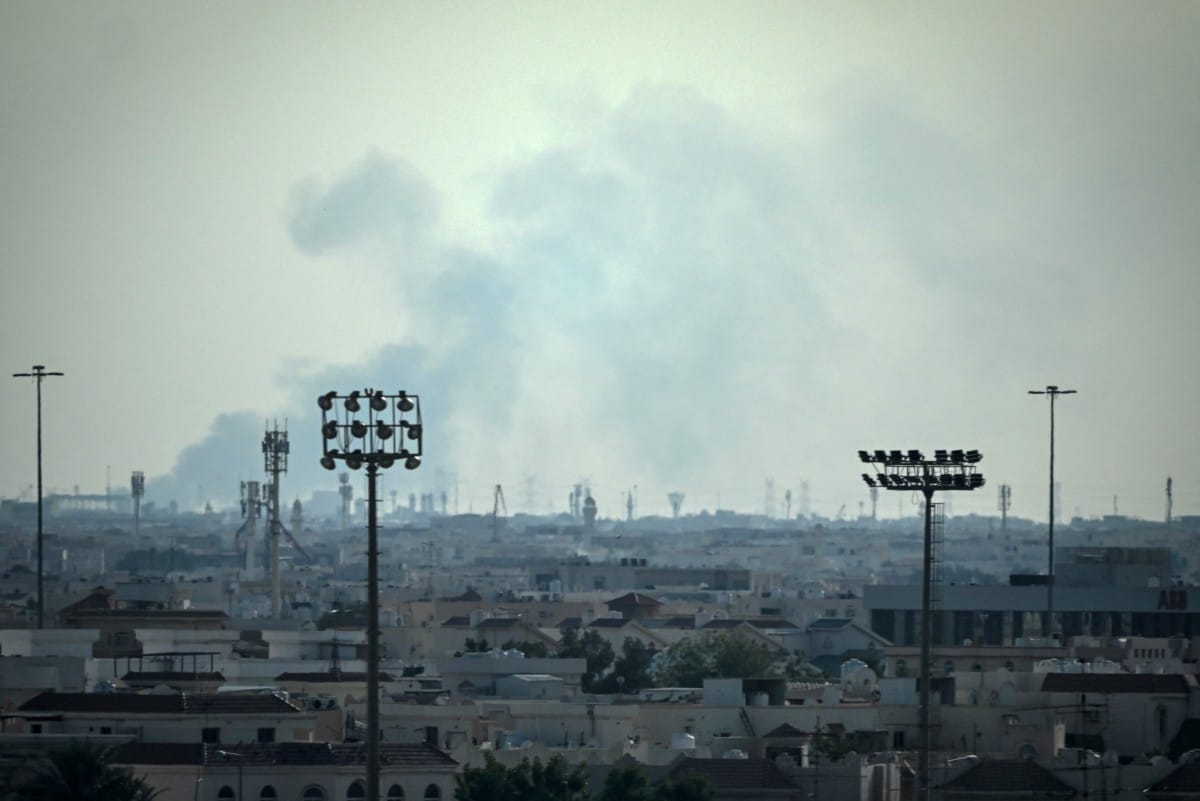 Smoke rises from an area in the direction of Al Udeid Air Base, which houses the Qatar Emiri Air Force and foreign forces including the US, in Doha on February 28, 2026, following a reported Iranian strike.