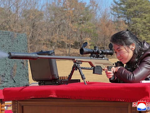 This picture taken on February 27, 2026 shows North Korean leader Kim Jong Un's daughter Kim Ju Ae firing a new sniper rifle, at an undisclosed place in North Korea. 