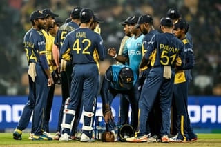Sri Lanka's head coach Sanath Jayasuriya (5R) speaks to players during the 2026 ICC Men's T20 Cricket World Cup Super Eights match between Sri Lanka and Pakistan at the Pallekele International Cricket Stadium in Kandy on February 28, 2026.