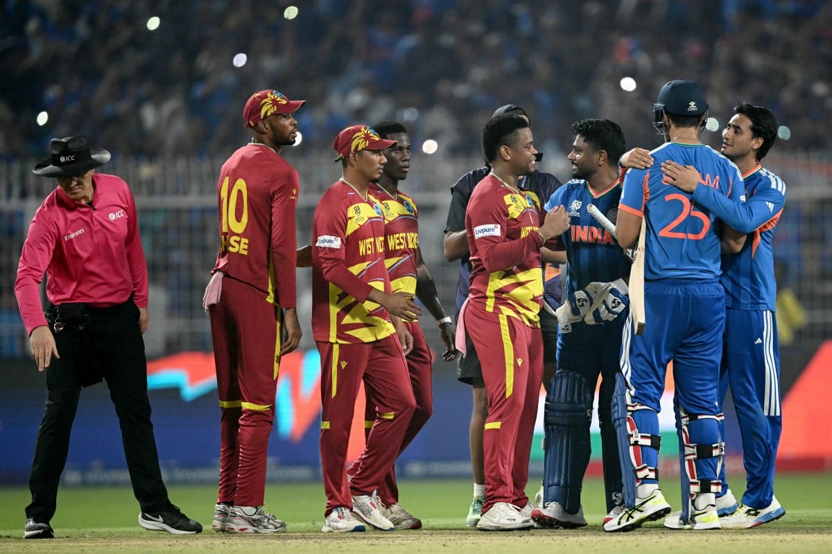 Umpire Alex Wharf gestures as West Indies' Roston Chase, Gudakesh Motie, Shamar Joseph and Shimron Hetmyer congratulate India's Sanju Samson, Shivam Dube and Abhishek Sharma for their team's win at the end of their 2026 ICC Men's T20 Cricket World Cup Super Eights match in the Eden Gardens, Kolkata on March 1, 2026.