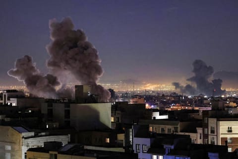 Smoke plumes rise following missile strikes in Tehran on March 1, 2026.