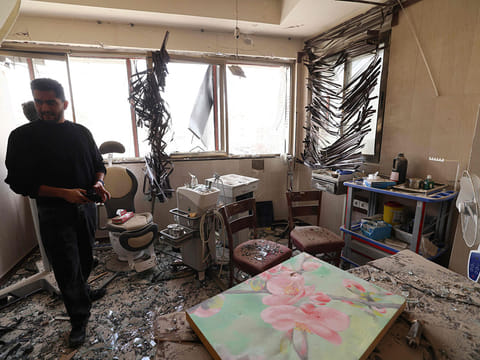A man looks at the damage inside the Gandi Hospital, which was hit March 1, when a projectile struck a state TV communications tower and nearby buildings across the street, during the ongoing joint US-Israeli military campaign on the capital Tehran on March 2, 2026. 
