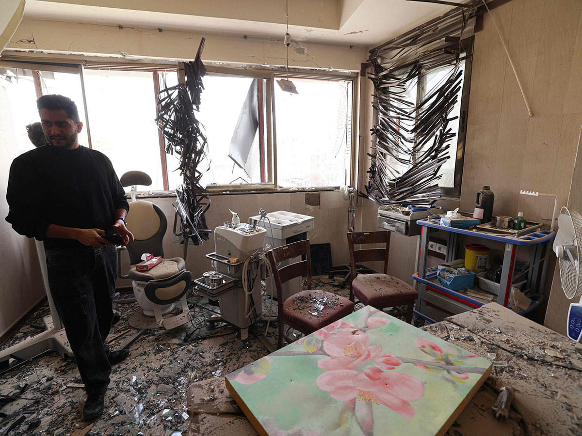 A man looks at the damage inside the Gandi Hospital, which was hit March 1, when a projectile struck a state TV communications tower and nearby buildings across the street, during the ongoing joint US-Israeli military campaign on the capital Tehran on March 2, 2026. 