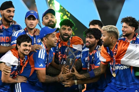 India's players celebrate with the trophy after winning the 2026 ICC Men's T20 Cricket World Cup final match against New Zealand at the Narendra Modi Stadium in Ahmedabad on March 8, 2026.
