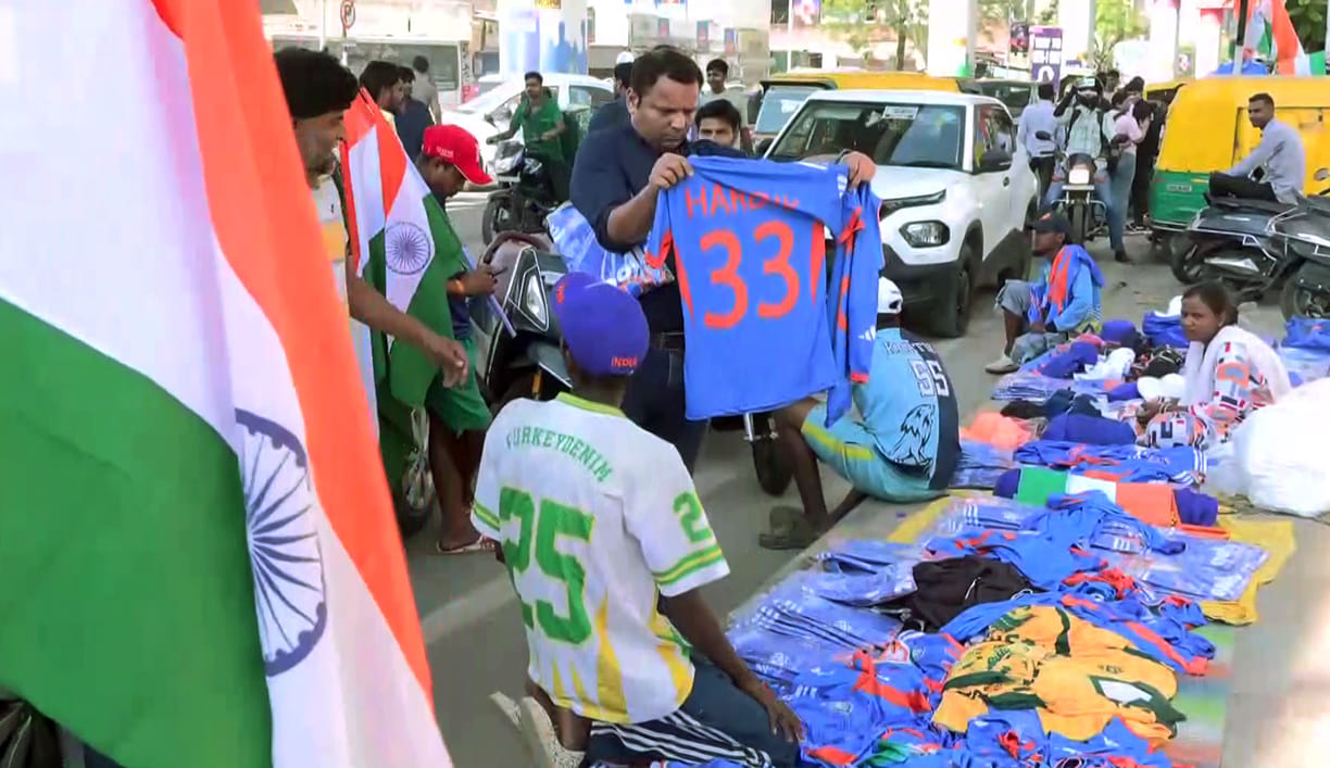 Cricket enthusiasts purchase jerseys for the T20 World Cup Final between India and New Zealand tomorrow