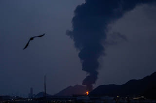 Large fire and plume of smoke is visible after, according to the authorities, debris of an Iranian intercepted drone hit the Fujairah oil facility, in Fujairah, United Arab Emirates, Tuesday, March 3, 2026. 