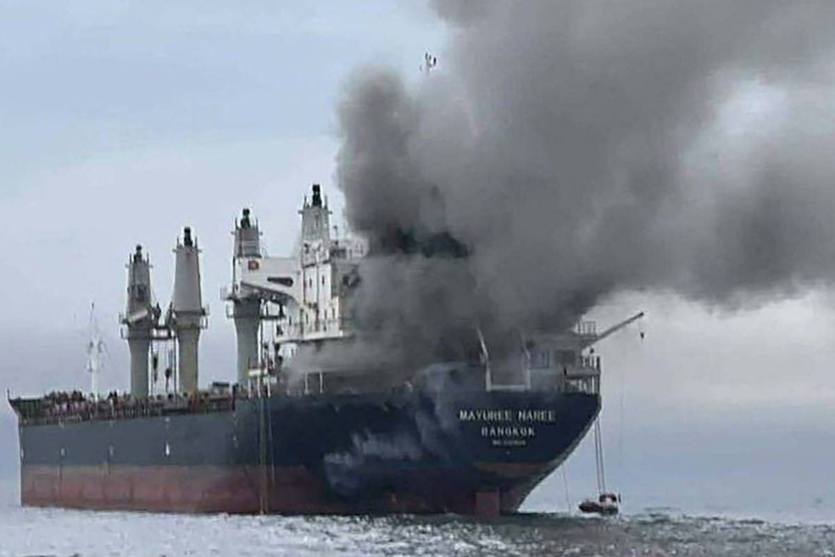 Smoke rising from the Thai bulk carrier 'Mayuree Naree' near the Strait of Hormuz after an Iranian attack.