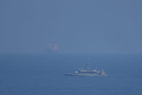 A UAE navy ship patrols the Strait of Hormuz as seen from Mina Al Fajer, United Arab Emirates, Wednesday, March 11, 2026. (AP Photo/Altaf Qadri)