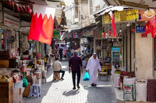 People walk along an alley at a bazaar in Bahrain's capital Manama on March 11, 2026.