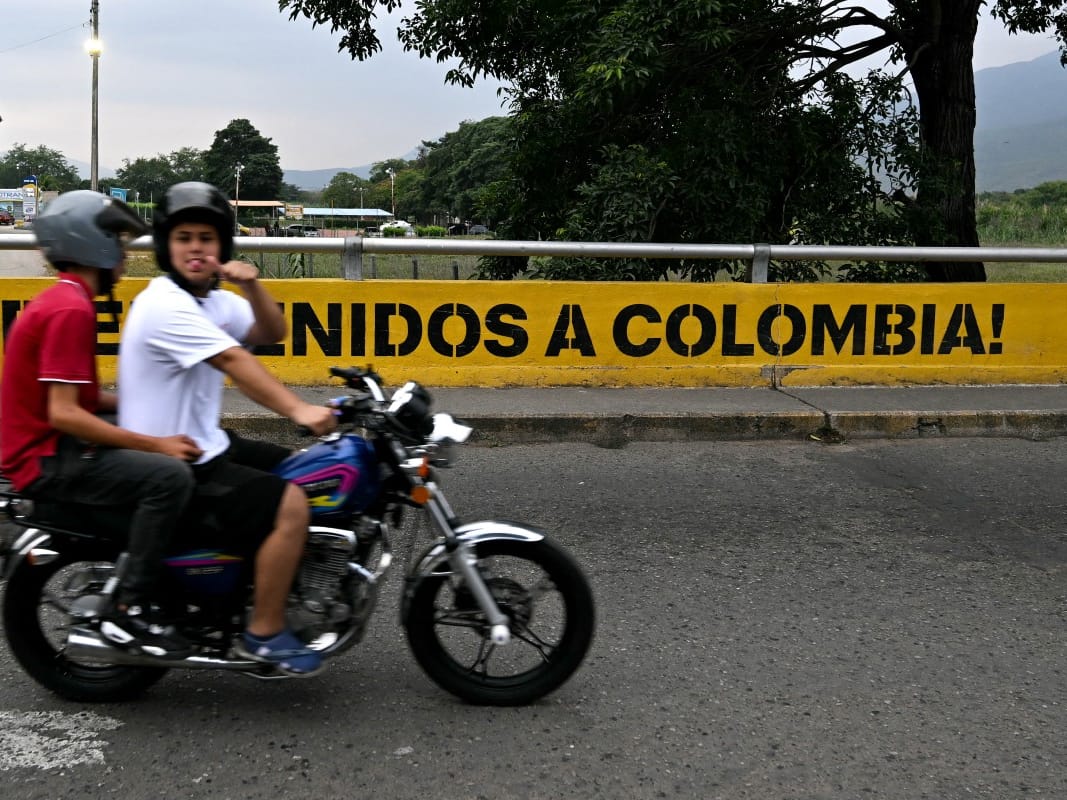 A man riding a motorbike gestures as he crosses the Colombia-Venezuela border at the Simon Bolivar International Bridge on the outskirts of Cucuta, Colombia 
