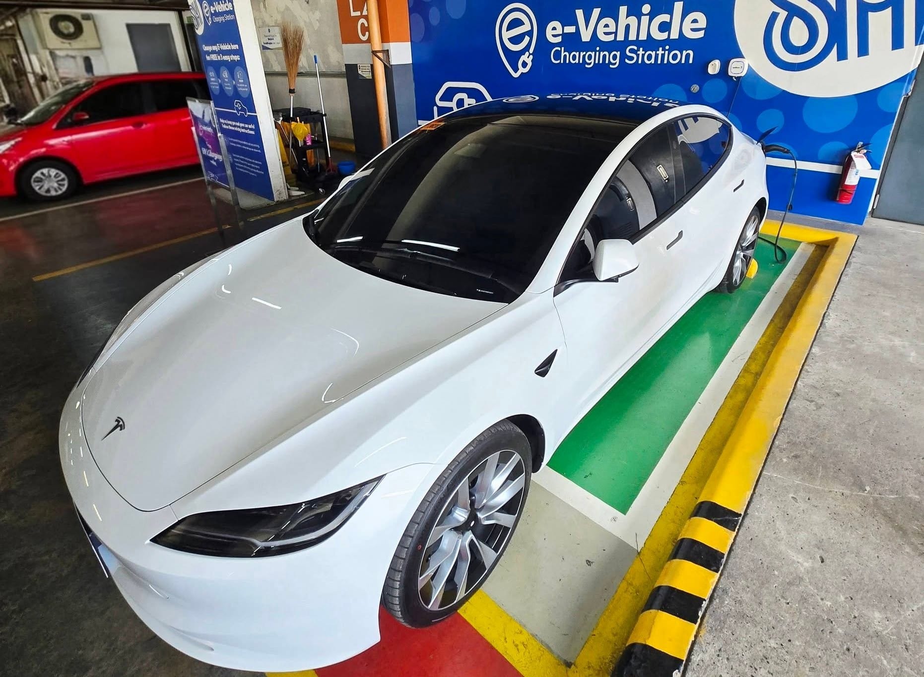 Filipino businessman Glenn Cuarto, a former OFW from the UAE, charges his Tesla Model 3 at a local mall (SM City Iligan, in Mindanao). Plug-in car sales have jumped 600% in February alone, before the Middle East war erupted.