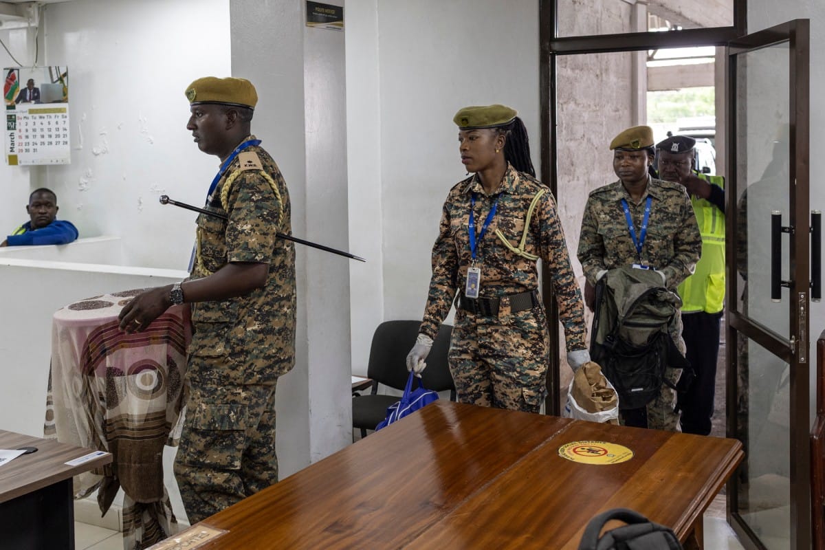 Kenya Wildlife Services wardens deliver exhibits of live ants confiscated from Chinese national, Zhan Kequn and his co-accused Kenyan, Charles Mwangi (both not in picture) to the Jomo Kenyatta International Airport (JKIA) law courts, before the accused arraignment to take a plea against charges of dealing in wildlife species contrary to laws regulating wildlife conservation after they we're found in possession of more than two thousand live ants intended to be trafficked internationally in Nairobi on March 17, 2026.