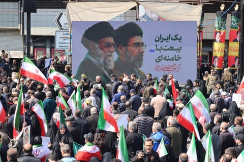 Mourners participate in a procession during the funeral of Iran’s national security chief Ali Larijani, Basij commander Gholamreza Soleimani and Iranian sailors killed in recent strikes, in Tehran on March 18, 2026.