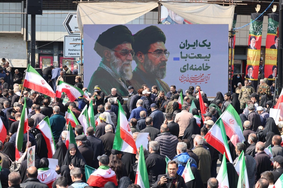 Mourners participate in a procession during the funeral of Iran’s national security chief Ali Larijani, Basij commander Gholamreza Soleimani and Iranian sailors killed in recent strikes, in Tehran on March 18, 2026.
