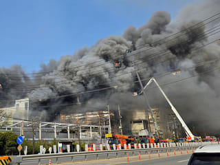 Heavy smoke rise following a fire at a car parts plant in Daejeon on March 20, 2026. A fire at a car parts plant in South Korea on March 20 seriously injured at least 21 people and left 14 others missing, authorities said. 