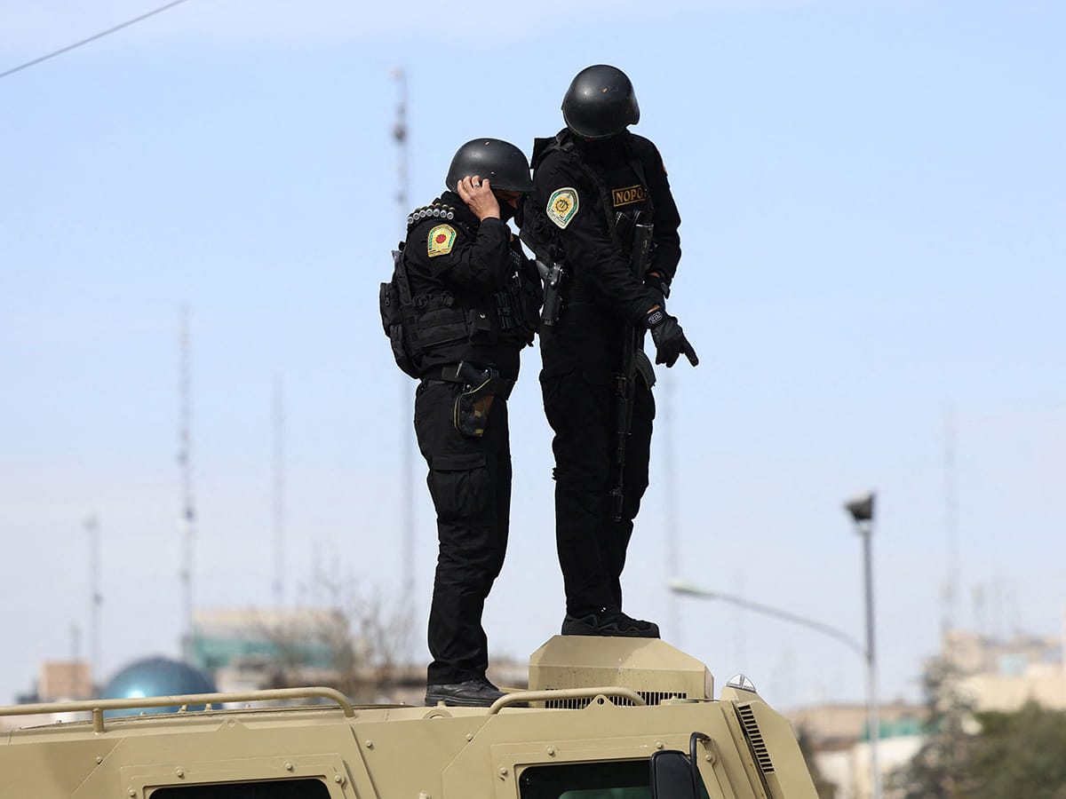 Iranian security forces stand guard on top of an armoured vehicle during the funeral ceremony of Iran's Revolutionary Guards spokesperson Ali Mohammad Naini, who was killed in US-Israeli strikes, in Tehran on March 21, 2026.