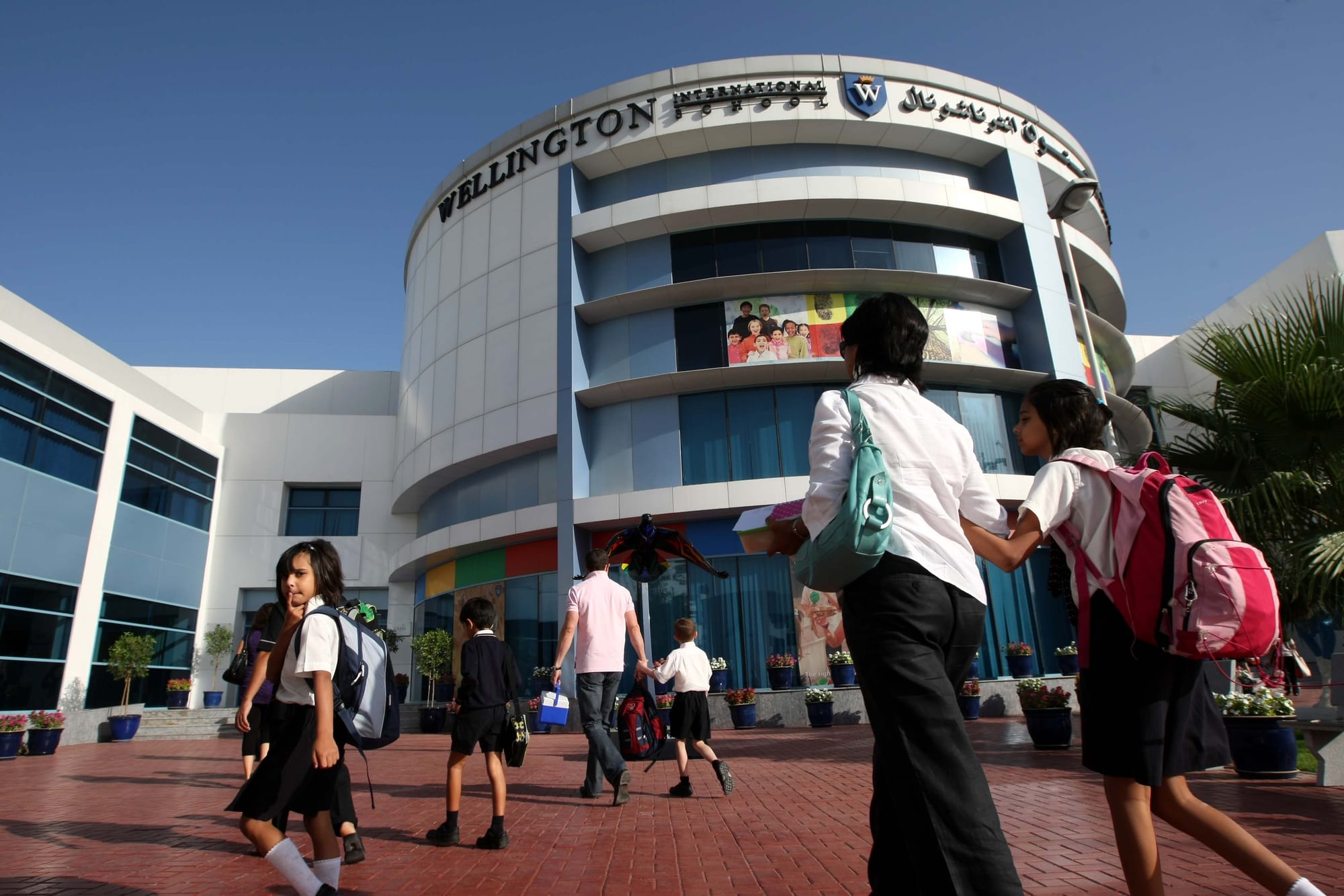 Parents and students head for the front doors of the GEMS Wellington International School in Al Sufouh, Dubai. 