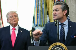 US President Donald Trump looks on as Secretary of Defense Pete Hegseth speaks during a swearing in ceremony for new Homeland Security Secretary Markwayne Mullin in the Oval Office of the White House in Washington, DC, on March 24, 2026.
