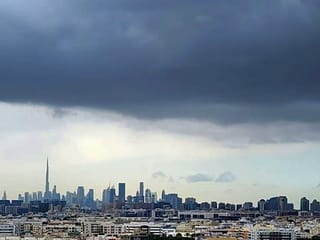A blanket of dark clouds covers Dubai’s skyline