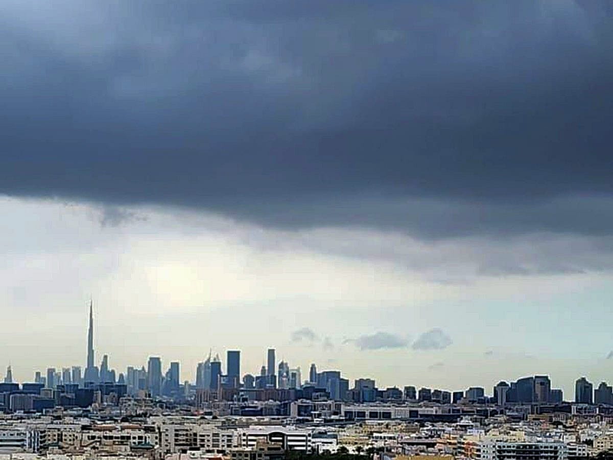 A blanket of dark clouds covers Dubai’s skyline