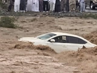 Motorist rescued after car swept by flash floods