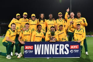 South Africa's Keshav Maharaj (front 3rd R) holds the series trophy as he and his teammates pose after winning the fifth Twenty20 international cricket match between New Zealand and South Africa at Hagley Oval in Christchurch on March 25, 2026.
