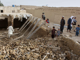 Locals inspect a damaged house following floods, landslides and thunderstorms in Kandahar province, Afghanistan, Sunday, March 29, 2026. 