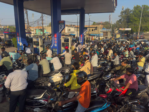 Commuters wait in long queues for fuel at a petrol station in Prayagraj, India, Thursday, March 26, 2026, amid fears of shortages following the escalation of the U.S.-Israel-Iran conflict. (AP Photo/Rajesh Kumar Singh)
