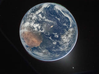 Earth as seen through the Orion spacecraft’s window, photographed by NASA astronaut Reid Wiseman, commander of Artemis II, on April 2, 2026, after completing the translunar injection burn. 