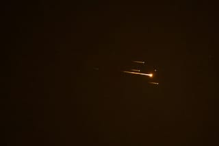 Rocket trails are seen in the sky above the Israeli coastal city of Netanya amid a fresh barrage of Iranian missile attacks on April 4, 2026.