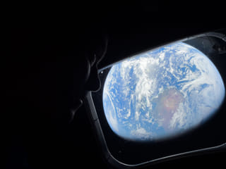 Artemis 2 astronauts take a moment to look back at Earth as they continue deep into space toward the Moon.