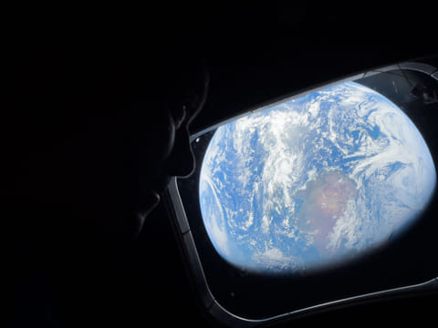 Artemis 2 astronauts take a moment to look back at Earth as they continue deep into space toward the Moon.