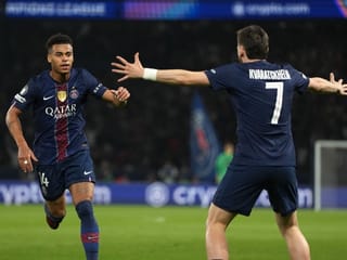 PSG's Desire Doue, left, celebrates with PSG's Khvicha Kvaratskhelia after scoring the opening goal during the Champions League quarterfinal first leg soccer match between Paris Saint-Germain and Liverpool in Paris, Wednesday, April 8, 2026. (AP Photo/Thibault Camus)