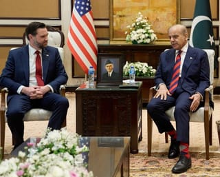 US Vice President JD Vance (L) speaks with Pakistani Prime Minister Shehbaz Sharif ahead of their meeting on Iran amid the US-Iran peace talks in Islamabad. File photo taken on April 11, 2026.