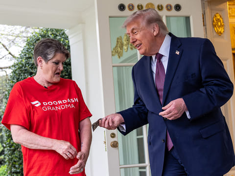 Sharon Simmons, with DoorDash, delivers McDonald's to President Donald Trump outside the Oval Office of the White House.
